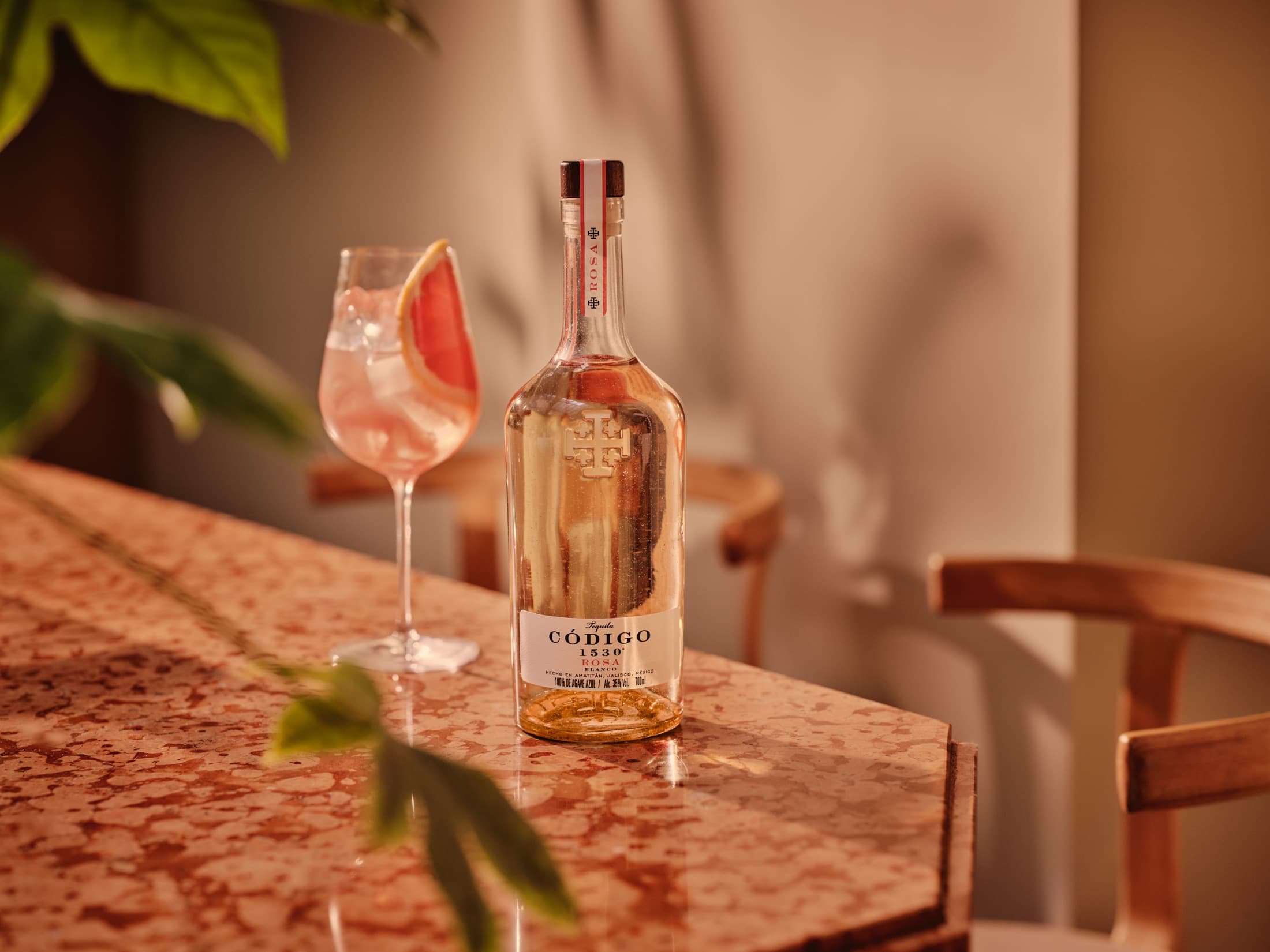 Codigo 1530 bottle with cocktails on a tabletop
